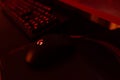 Famous gaming mouse Logitech G403 with red logo, glowing Logitech G413 led