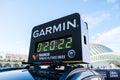 Valencia, Spain - December 3, 2022: Garmin sponsors the timing of the Valencia marathon, with digital clock on a car