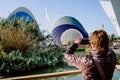 Valencia, Spain - December 28, 2019: Tourist photographs with his cell phone the buildings of the oceanografic of Valencia during