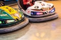 Valencia, Spain - December 14, 2018: Two children`s bumper cars competing among them at an amusement park Royalty Free Stock Photo