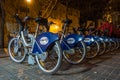Bikes for hire at night in Valencia Spain on February 24, 2019. Four unidentified people