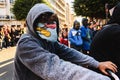 Valencia, Spain - February 16, 2019: Young man with hood and face covered by the streets of a city during a protest