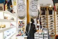 Valencia, Spain - January 2, 2019: White sneakers hanging with loose laces in a fashion clothing store Royalty Free Stock Photo