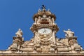 VALENCIA, SPAIN - JULY 15, 2020: Gothic clock on a tower with decoration and statues in Valencia