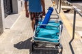 Valencia, Spain - June 23, 2019: Holiday vacationers head to the beach with inflatable chairs and mattresses to enjoy summer