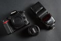 Valencia, Spain - 30 June 2019. Nikon D7000 body, nikkor lens and flash in black background