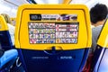 Valencia, Spain - March 8, 2019: Back of the seats of a Boeing plane with safety instructions, mandatory reading for passengers