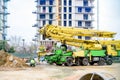 Valencia, Spain - March 5, 2021: A concrete pumper operated by a worker on a construction site Royalty Free Stock Photo