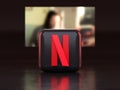 Valencia, Spain - March, 2023: Netflix app logo in front of a TV screen, icon in 3D illustration. Netflix is a global provider of