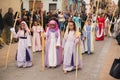 Valencia, Spain - March 24, 2024: People in religious costumes take part in the Palm Sunday procession In Valencia, Spain