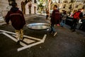 Valencia, Spain - March 19, 2019: Two chefs transport a huge paella pan to prepare the traditional Valencian rice