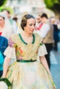 Valencia, Spain - March 17, 2019: The Valencian women wear the traditional fallero suit and the typical hairstyle with bow adorn