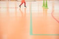 Valencia, Spain - May 9, 2019: Background of an indoor sports court with legs of a child running while exercising during a class