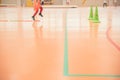 Valencia, Spain - May 9, 2019: Background of an indoor sports court with legs of a child running while exercising during a class