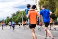 Valencia, Spain - May 19, 2019: Father carrying in his arms his son who participates in a popular running race