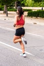 Valencia, Spain - May 19, 2019: Female athlete, rear view, running at high speed on the asphalt of the streets, elite sports women