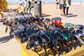 Valencia, Spain - May 12, 2019: Illegal immigrants selling false glasses and souvenirs to tourists on the beach of Valencia