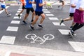 Valencia, Spain - May 19, 2019: Popular runners crossing a pedestrian crossing and bike path during a competition