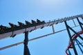 Valencia, spain - May 20, 2022: A tall, slender metal structure supports a fun roller coaster ride on a sunny summer day Royalty Free Stock Photo