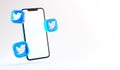 Valencia, Spain - October, 2021: Isolated Twitter icons with a blank screen mobile phone in 3D rendering. Twitter is a free social