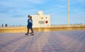 Valencia, Spain; 05/25/2020. People with masks strolling along the Valencia promenade, in front of the red cross lifeguard station Royalty Free Stock Photo