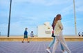 Valencia, Spain; 05/25/2020. People with masks strolling along the Valencia promenade, in front of the red cross lifeguard station Royalty Free Stock Photo