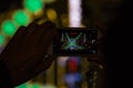 Cell phone photographing Calle de Cuba lights