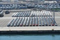 Recently discharged new cars, lorries and busses are parking in port of Valencia.