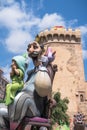 Cartoon king paper mache figure made for `Fallas` celebration in front of `Torres de Quart` city tower in Valencia, Spain