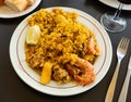 Valencian seafood paella with shrimps, squid and clams