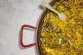 Paella chicken and rabbit dish in its pot served on the table with white tablecloth Royalty Free Stock Photo