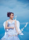 Valentin angel teen girl in white angels dress with wings. Valentines teenager girl with bow arrow. Royalty Free Stock Photo