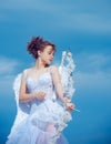 Valentin teenager girl with bow arrow ready to shoot. Cute angel teen with feathers wings on sky. Valentines Day. Royalty Free Stock Photo