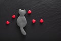 Valentine background edibale edible single black cat cookies and fondant sugar red hearts on black background with copy space Royalty Free Stock Photo