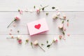 Valentine background with handmade paper with heart in pink rose flowers circle on white rustic wood Royalty Free Stock Photo