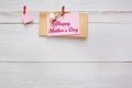 Mothers day background, heart and paper card on clothespins at wooden pillow hearts border on wood, copy space