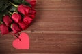 Valentine background of heart shape gift tag and red roses on wood. Space fo Royalty Free Stock Photo