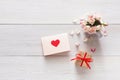 Valentine background pink rose flowers bouquet petals, gift box, handmade greeting card with hearts on white rustic wood Royalty Free Stock Photo