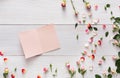 Valentine background with scattered pink rose flowers and petals on white rustic wood Royalty Free Stock Photo