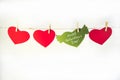 Valentine background with sewed pillow hearts row border on red clothespins at rustic white wood planks. Happy lovers Royalty Free Stock Photo