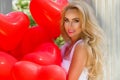 Valentine Beautiful girl with red balloons laugh, in the park. Beautiful happy young woman.