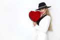 Valentine Beauty, elegant girl with red heart with roses. Portrait of a young female model with gift and hat. Royalty Free Stock Photo