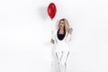 Valentine Beauty girl with red air balloon portrait, isolated on background. Beautiful Happy Young woman in an elegant tuxedo.