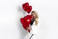 Valentine Beauty girl with red air balloon portrait, isolated on background. Beautiful Happy Young woman in an elegant tuxedo.