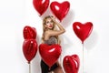 Valentine Beauty girl with red air balloon portrait pointing hand, isolated on background. Royalty Free Stock Photo