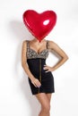 Valentine Beauty girl with red air balloon portrait pointing hand, isolated on background. Royalty Free Stock Photo