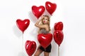 Valentine Beauty girl with red air balloon portrait pointing hand, isolated on background. Royalty Free Stock Photo