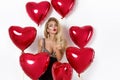 Valentine Beauty girl with red air balloon portrait pointing hand, isolated on background. Royalty Free Stock Photo
