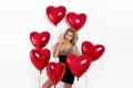 Valentine Beauty girl with red air balloon portrait pointing hand, isolated on background. Royalty Free Stock Photo