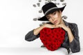 Valentine Beauty girl with red heart roses. Portrait of a young female model with gift and hat, isolated on background. Royalty Free Stock Photo